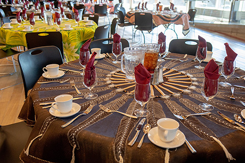 Tables set with colorful tablecloths at an Elson S. Floyd Cultural Center event.